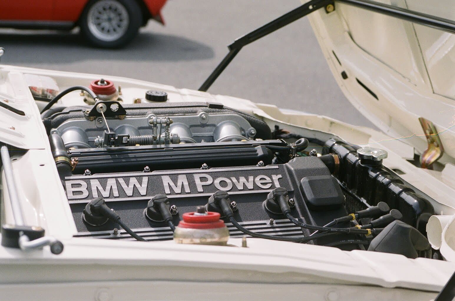 Engine bay of an E30 M3 with the M Power valve cover visible