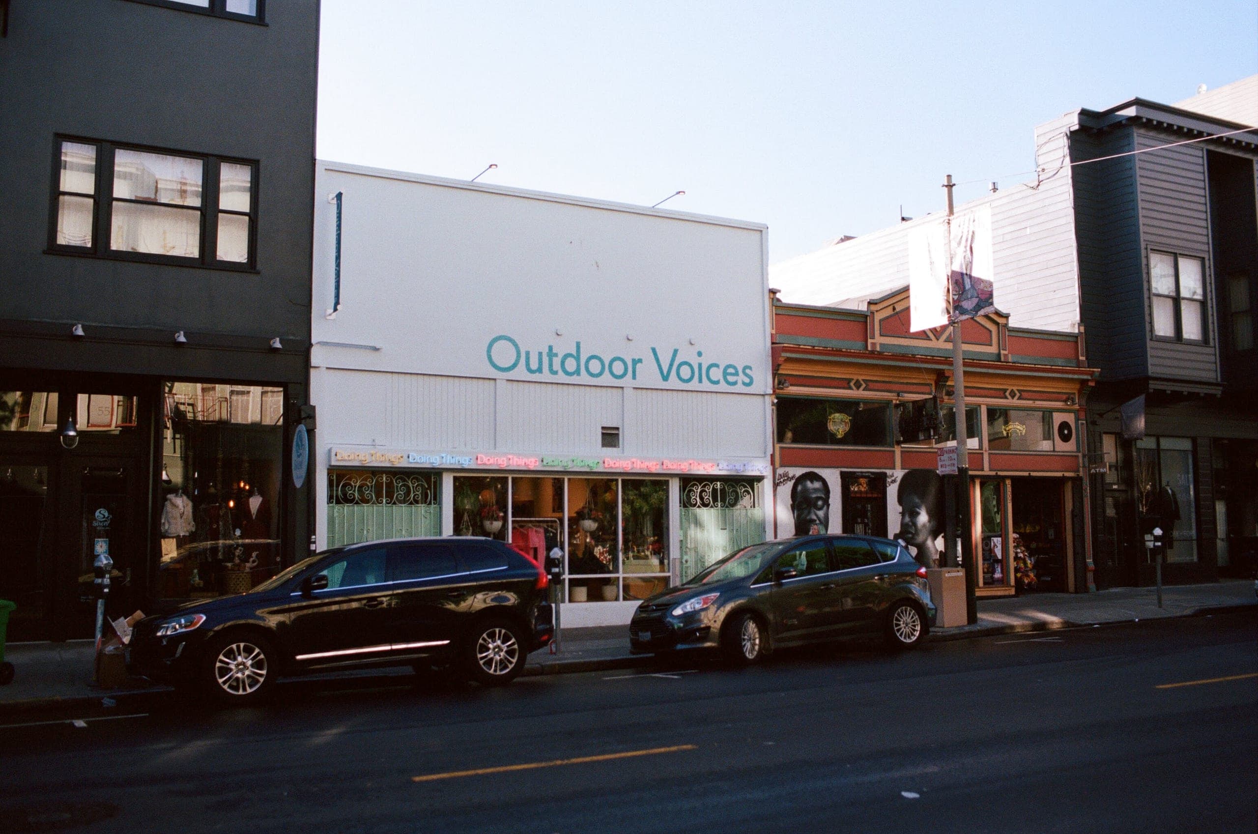 Outdoor Voices storefront on Valencia Street with parked cars in front